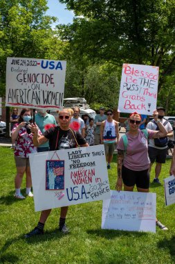 Philadelphia, PA USA-06-25-2022 Women in a crowd of men and women at political pro-choice rally hold pro-women's rights signs, USA declared genocide on American women and Blessed be the pussy that grabs back. Josh Shapiro rally. Editorial use only.