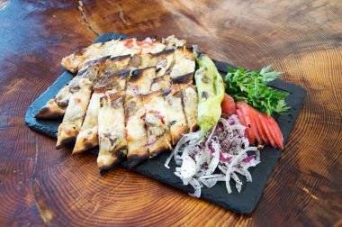 Doğranmış Türk pizzası, peynirli ve kıymalı.