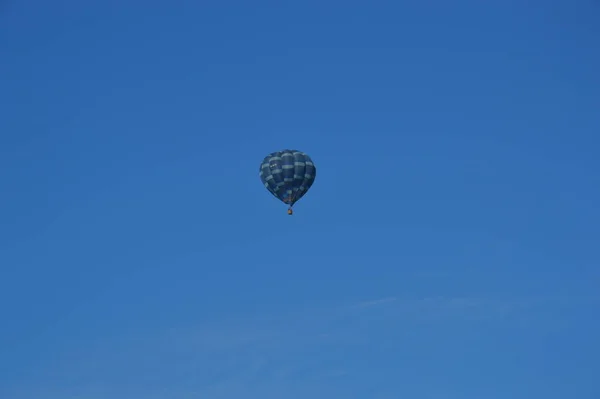 Hot air balloon flying over magnificent white travertines in Pamukkale