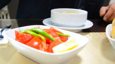 customer drinking the soup he ordered at the table