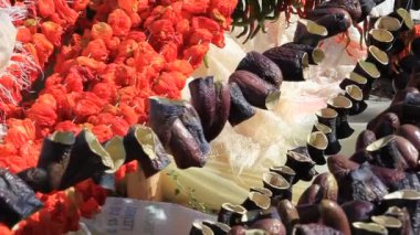 peppers left to dry in the sun by stringing on strings