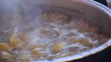 black cauldron cooking on wood fire