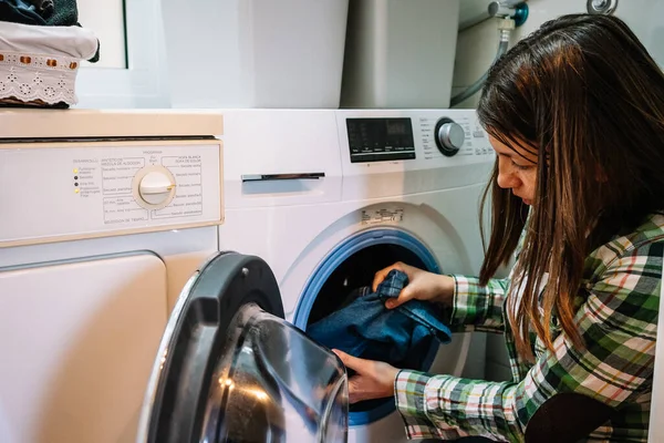 woman puts washing machine at home. High quality photo