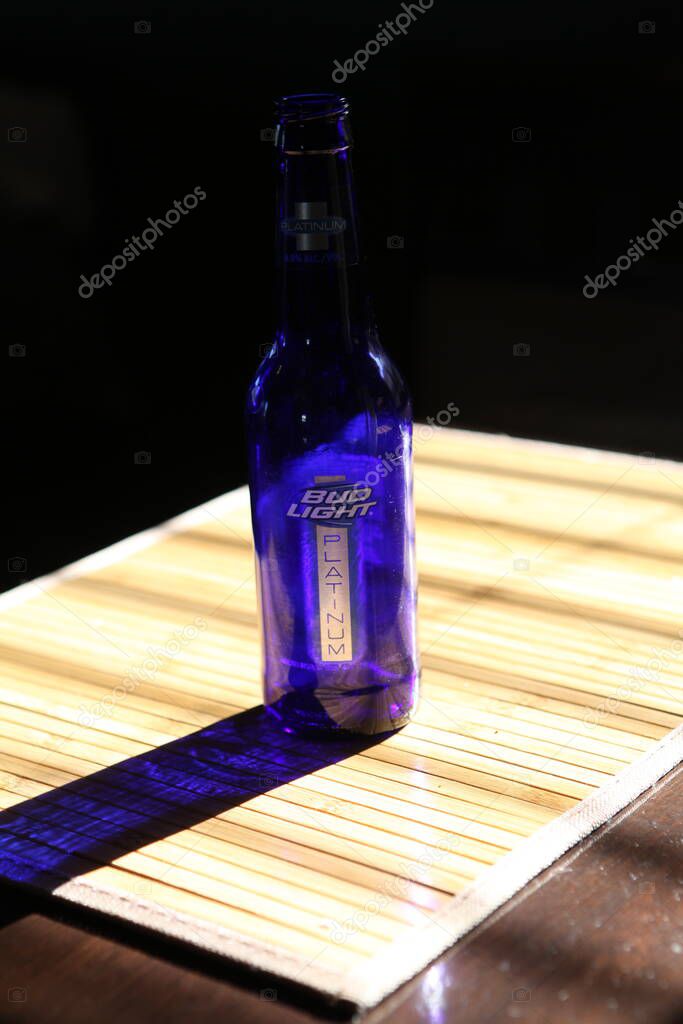 Columbus,Ohio July 5, 2020 Bud Light Beer Bottle in high sun drawing long shadows.