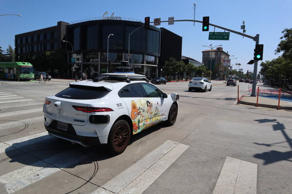 Culver City CA  August 12, 2025 Self-driving Waymo car navigates urban intersection in Los Angeles. 