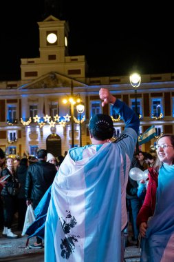 Arjantin bayrağını taşıyan taraftarlar, Madrid 'in Sol Meydanı' ndaki Dünya Kupası zaferini kutluyorlar..