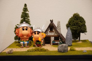 Horizontal shot of a diorama about asterix and obelix with vinyl figures from the funko pop company.