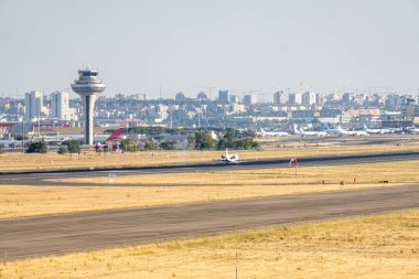 White mitsubishi CRJ-200ER with cantabria sticker, from iberia regional airline with spanish flag and registration EC-HEK with the landing gear down.