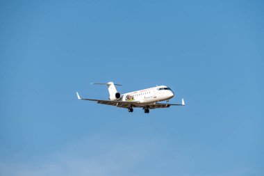 White mitsubishi CRJ-200ER with cantabria sticker, from iberia regional airline with spanish flag and registration EC-HEK with the landing gear down.