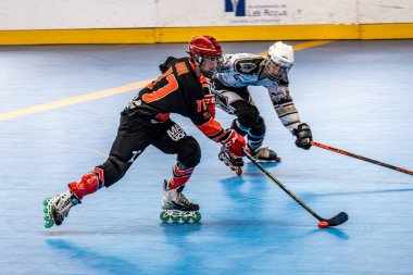 Men's match of the Spanish elite league of inline field hockey between the teams of cannibals and rubi in the rink of las rozas. clipart