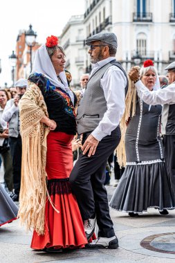 Madrid, İspanya. 15 Mayıs 2023. Madrid 'in tipik kostümleriyle Chulapos gibi giyinmiş çiftler şehrin merkezinde Puerta de Sol' un km 'sinde dans ediyorlar..