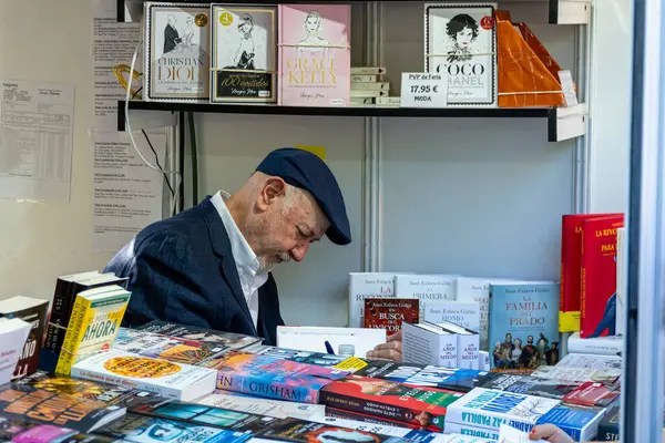 stock image Madrid, Spain- June 16, 2024. Writer Juan Eslava Galan signing books at a stand at the Madrid book fair on the closing Sunday.