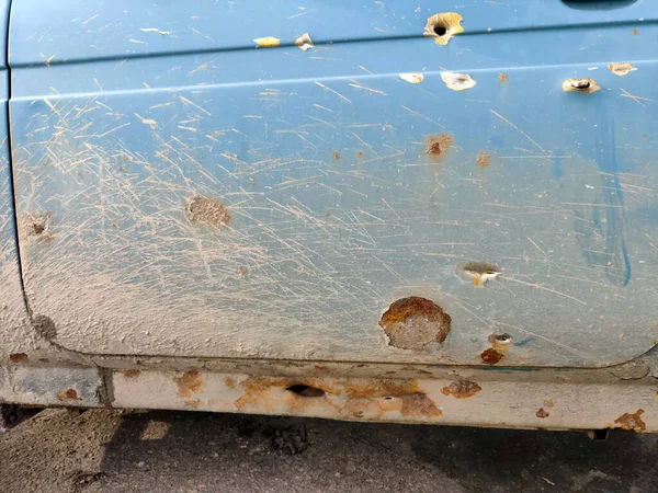 Damaged car during the war in Kherson Ukraine. The car of civilians was damaged in a centre city december 24, 2022. Shrapnel missile attack in the car body. War of Russia against Ukraine.