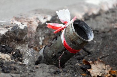 Fragment of a Russian rocket 122mm hail sticking out of the asphalt in the center of Kherson, Ukraine. Genocide of the Ukrainian. Russia shells the civilian population and the city. War crimes. BM-21