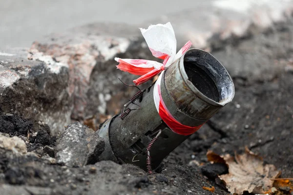 Fragment of a Russian rocket 122mm hail sticking out of the asphalt in the center of Kherson, Ukraine. Genocide of the Ukrainian. Russia shells the civilian population and the city. War crimes. BM-21