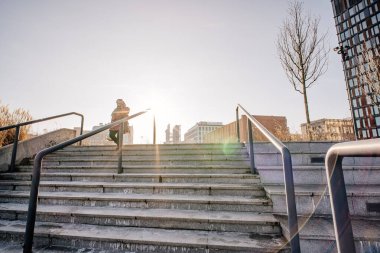 Kaykaylı biri merdivenlerden çıkıyor.