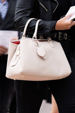 Milan, İtalya - 21 Eylül 2022: Trussardi 'den bej renkli Iris çanta taşıyan kadın, sokak tarzı kıyafet ayrıntıları.
