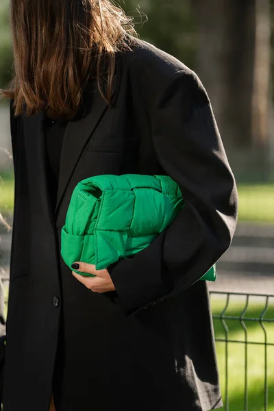 stock image Milan, Italy - September, 22, 2022: woman wears green padded tech cassette crossbody bag from Bottega Veneta, street style outfit details