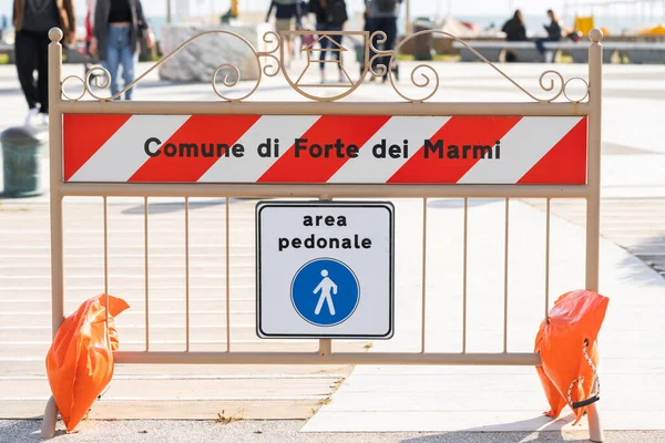 Pedestrian area sign. White square road sign indicating the entrance to a pedestrian zone in Italian. Road sign with the inscription Area pedonale which means Pedestrian area in Forte dei Marmi
