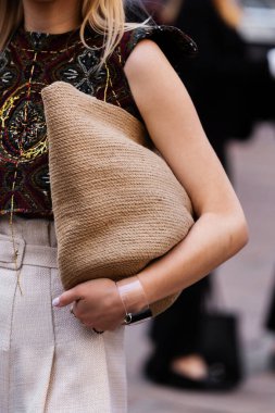 Milan, İtalya - 22 Eylül: Kadın nüfuzlu, rafya çantası takıyor. Moda blogcusu kıyafet detayları, sokak tarzı