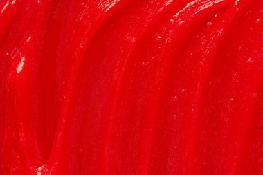 Kırmızı jel dokusu. Kozmetik temiz sıvı krem lekesi. Cilt bakım ürünleri numunesi yakın çekim. Diş macunu veya ağda arkaplanı