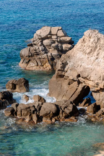 stock image Waves on rocky beach, sea shore with waves crushing over the big rocks, summer sunny day