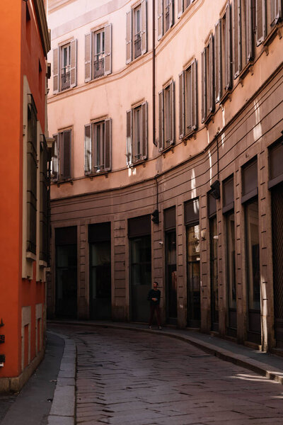 Milan, Italy - March, 25, 2023: People walking in streets of historical part of Milan, vertical view