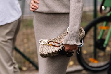 Milan, Italy - September 20, 2023: fashioner wearing Fendi shoulder bag. Fashion blogger outfit details, street style clipart