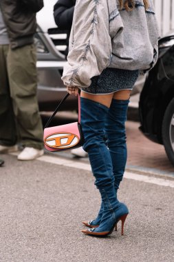 Milan, İtalya - 22 Şubat 2023: Diesel 1DR omuz çantası ve bot giyen modacı. Moda blogcusu kıyafet detayları, sokak tarzı