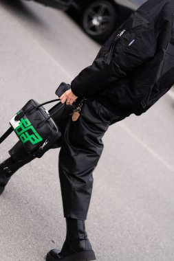 Milan, Italy - January, 14, 2024: man wears Prada City Calfskin Racing logo Bowler handbag, street style bag details, fashion outfit detail clipart