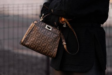 Milan, Italy - January, 13, 2024: man wears Fendi bag, street style details, fashion outfit detail clipart