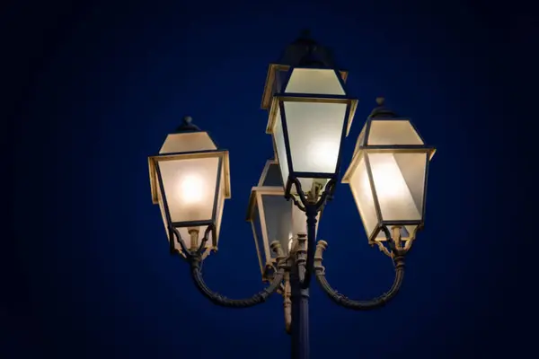 Vintage street light against the evening blue sky, city lantern