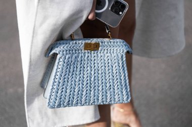 Milan, Italy - February, 21, 2024: woman wears Fendi Peekaboo bag, fashion blogger outfit details, street style. clipart