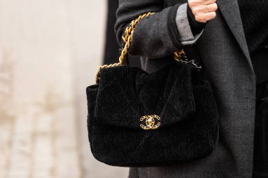 Paris, France - January, 24, 2024: woman wears Chanel bag, street style details, fashion outfit detail. clipart