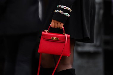 Paris, France - February, 29, 2024: woman wears Hermes Kelly bag, fashion blogger outfit details, street style. clipart