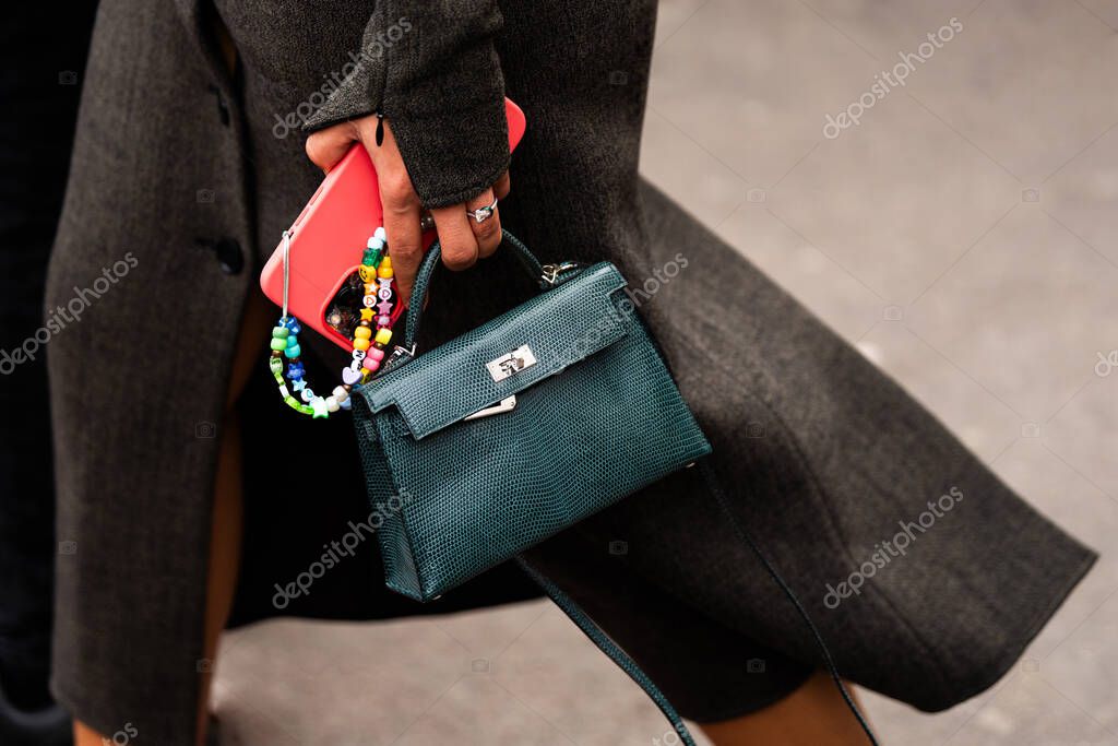 Paris, France - February, 29, 2024: woman wears Hermes Kelly bag, fashion blogger outfit details, street style.