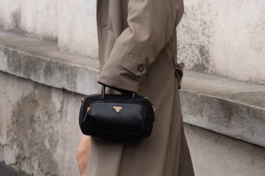 Milan, Italy - February, 22, 2024: woman wears Prada bag, fashion blogger outfit details, street style clipart