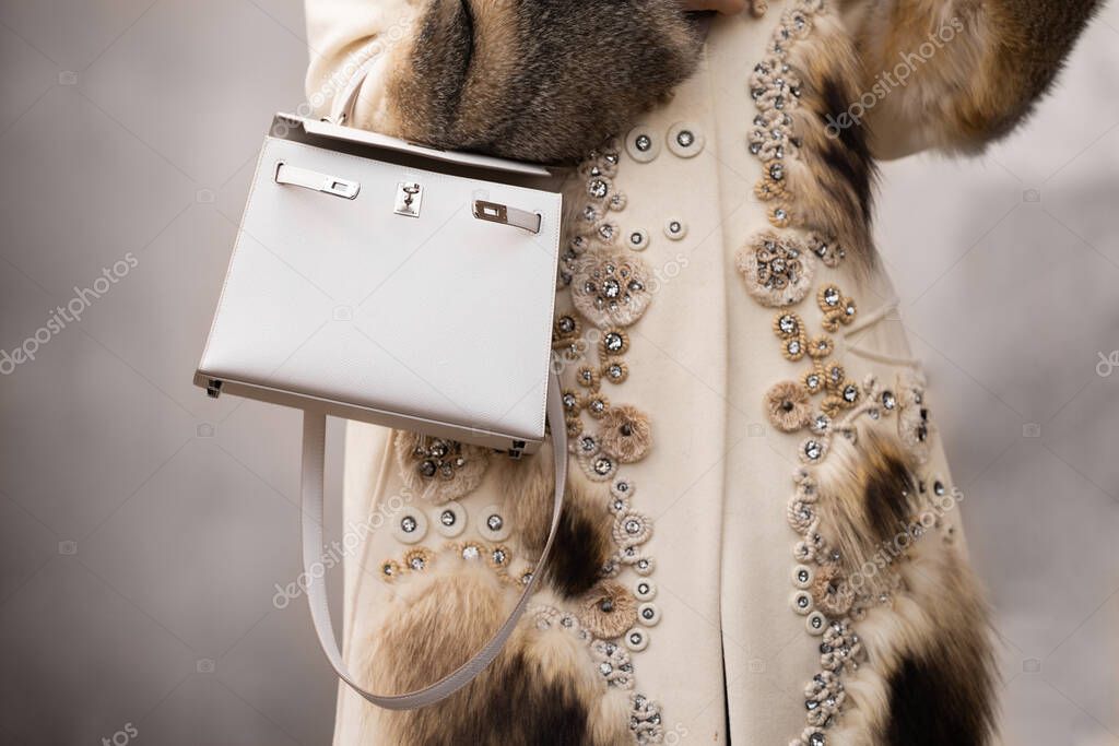 Paris, France - February, 29, 2024: woman wears Hermes Kelly bag, fashion blogger outfit details, street style.