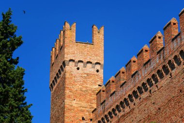 Gradara, Italy - August, 25, 2022: close up of towers on Gradara Castle, Italy, against clear blue sky clipart