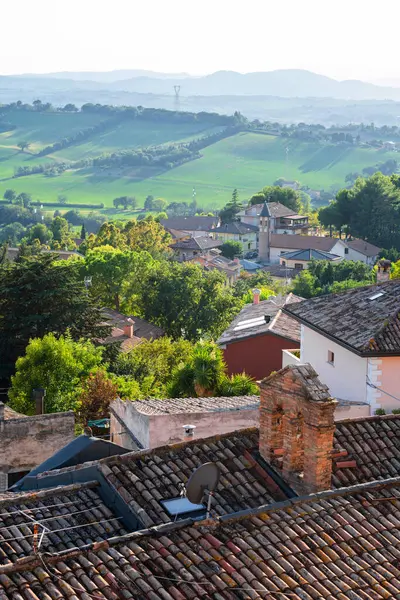 Gradara, İtalya - 25 Ağustos 2022: Gradara köyünün çatıları ve kaleden çevreleyen yeşil alanlar