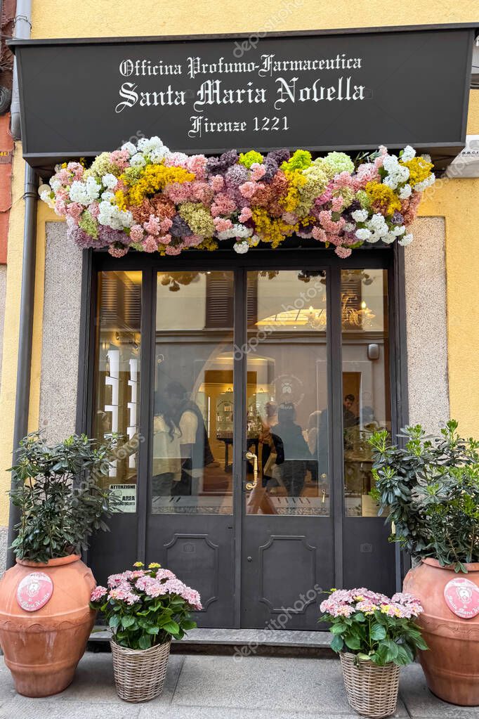 Milan, Italy - April, 12, 2025: Santa Maria Novella Florence 1221 boutique in Milan. Apothecary perfume shop with flowers and potted plants by entrance.