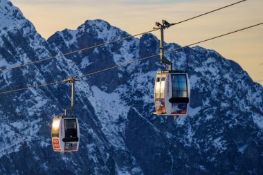 Piani di Bobbio, İtalya - 24.12.2022: Karla kaplı dağların üzerinden geçen iki teleferik, Alp manzarası ve sakin kış manzarası