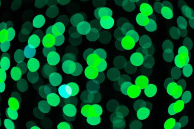 Şenlikli ve yaratıcı arkaplan tasarımı için canlı yeşil bokeh ışıkları.