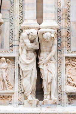 Milan, İtalya - 30 Ağustos 2022: Milan Duomo Katedrali üzerindeki Gotik mermer heykeller, dekorasyon heykelleri. İtalya 'nın en büyük kilisesi ve popüler turizm merkezi..