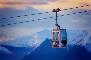 Piani di Bobbio, İtalya - 24.12.2022: Tek bir teleferik karla kaplı dağ sırasının üzerinde seyahat ediyor. Tatiller, kar giysileri kiralama, kayak, snowboard ve dağ manzarası konsepti