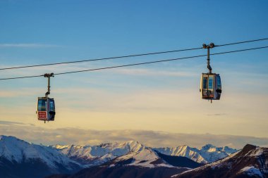 Piani di Bobbio, İtalya - 24.12.2022: Karla kaplı dağların üzerinden geçen iki teleferik, Alp manzarası ve sakin kış manzarası