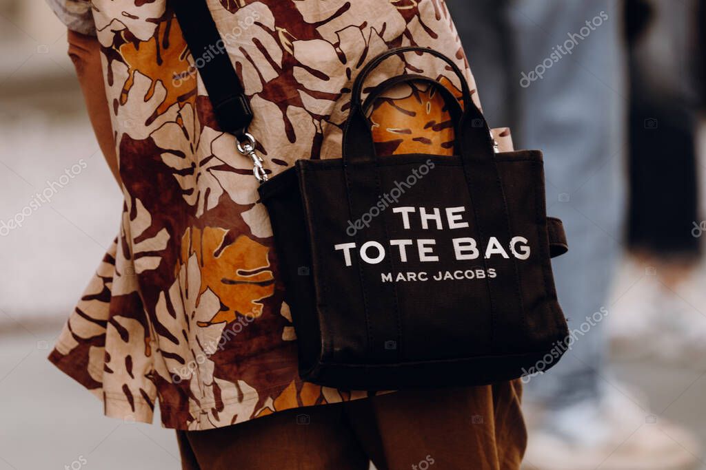 Milan, Italy - June, 14, 2023: Man wears The Tote bag Marc Jacobs. Fashion outfit details, street style