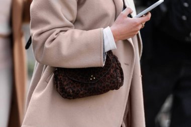 Milan, İtalya - 28 Mart 2024: Kadın Küçük Helmut leopar desenli çanta takıyor. Moda kıyafetleri, sokak tarzı.