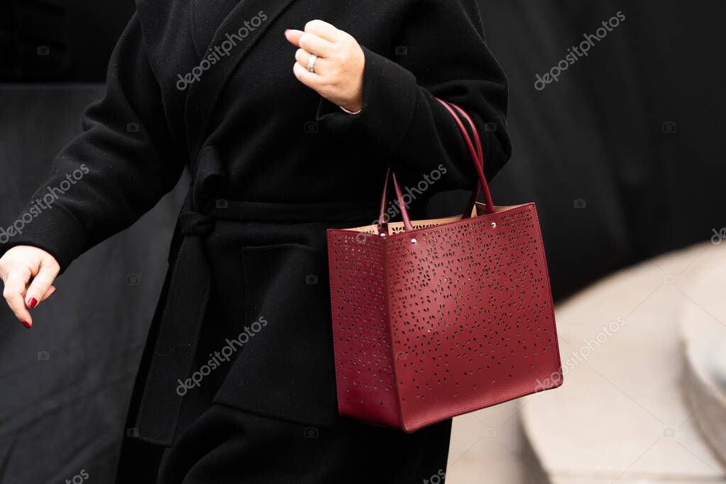 Milan, Italy - March, 25, 2024: Woman wears Alaia red handbag. Fashion outfit detail, street style