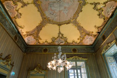 Milan, İtalya - 11 Nisan 2025: Barok ve Rococo tarzı tavan, alçı döşemeleri ve Murano avizesi ile tarihi Milan mimarisi Palazzo Litta 'da.